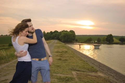 Couple hugging, during sunset. Stock Photos