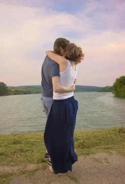 Couple hugging, during sunset. Stock Photos