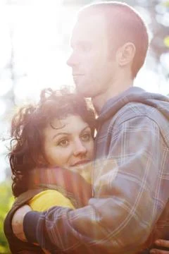 Couple hugging each other in sunlight Stock Photos