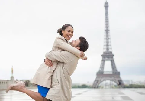 Couple hugging by Eiffel Tower, Paris, France Stock Photos