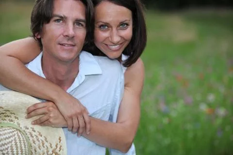 Couple hugging on the field Stock Photos