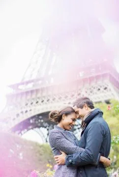 Couple hugging in front of Eiffel Tower, Paris, France Stock Photos