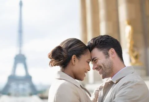 Couple hugging in front of Eiffel Tower, Paris, France Stock Photos