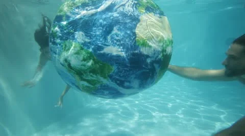 Couple hugging the Globe of Earth under water Stock Footage 12941650