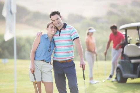 Couple hugging on golf course Fotos Stock