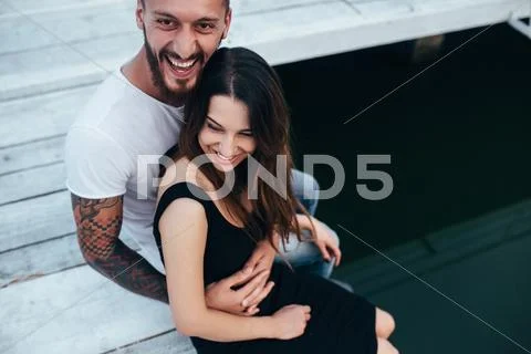 Couple hugging on pier Stock Photos