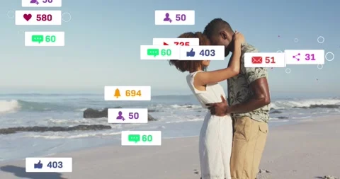 Couple hugging on sandy beach initiating marketing metrics with floating heart Stock Footage 327272589