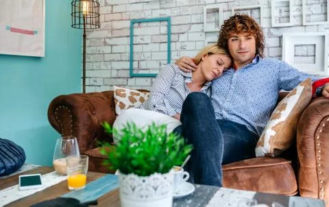 Couple hugging on a sofa Stock Photos