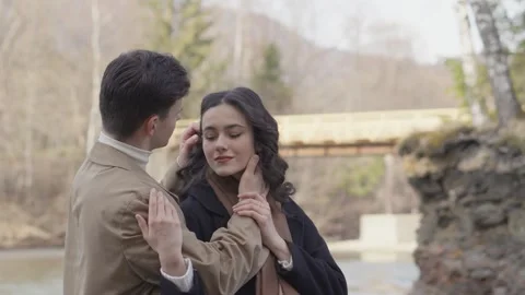 The couple hugging while enjoying a picnic by a forest lake, where water Stock-Footage 263653853