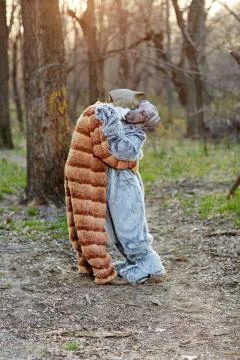 Couple hugging while wearing cat and dog costumes Foto stock