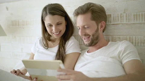 Couple with i pad in bed Stock Footage 62683861
