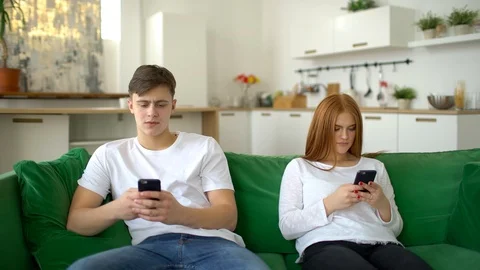 Couple ignoring each other using mobile phones. Anti-social couple ignore each Stock Footage 86188577