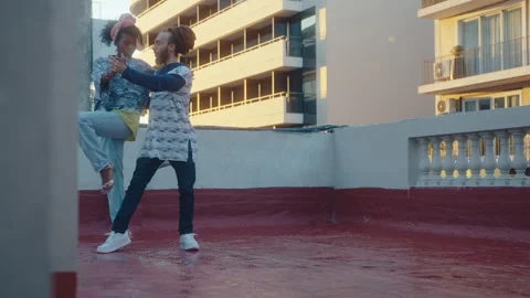 Couple Improvising and Performing Tango Dance on a Wet Rooftop Stock Footage 246774042