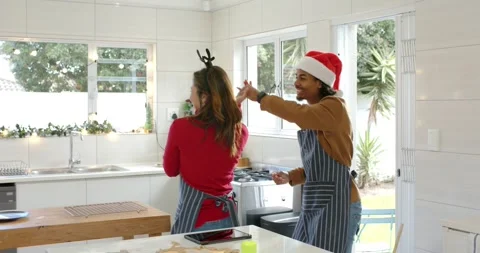 Couple initiating dance by starting cookie baking, holding hands, swaying into Stock Footage 343837442
