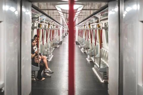 Couple inside almost empty metro train /  MTR subway train in Hong Kong Stock Photos