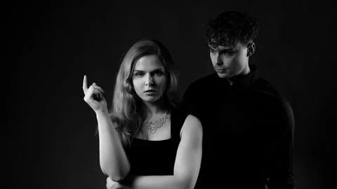 Couple interacting in dramatic black and white studio Stock Photos