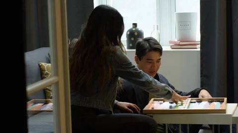Couple interacting with each other while playing board game at home Vídeos de archivo 111970291