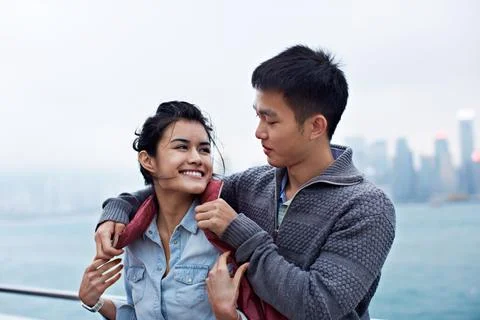 Couple, jacket and happy with help for cold, date and promenade for holiday Stock Photos