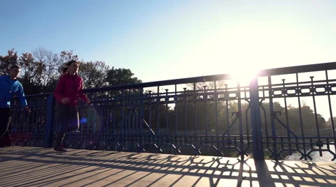 Couple jogging on the bridge, super slow motion Stock Footage 56874579