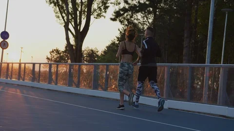 Couple jogging in the evening Stock Footage 100033312