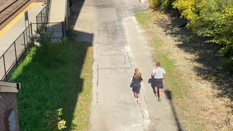 Couple jogs on the Green Bay Trail - overhead view Stock Footage 142725906