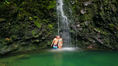 Couple Jumping Into Waterfall Pond Stock Footage 52995137