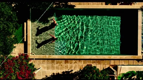 The couple jumps together in pool. Slow Motion. Stock Footage 213617013