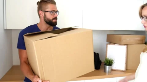 Couple just move to their new apartment. They are arguing about unpacking. Stock Footage 54989672