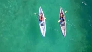 Couple Kayaking Near Rocks Tropical Water By Aerial Drone Stock Footage