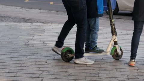 Couple with kid using electric shared scooter outdoor on the street. Stock Footage 122165776