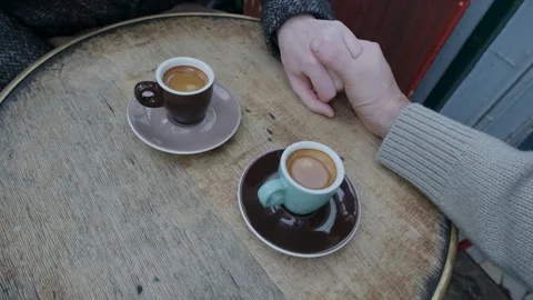 Couple kindly holding hands over expresso Stock Footage 277799463