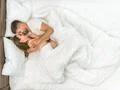 The couple kiss in the white linens. View from above Photo