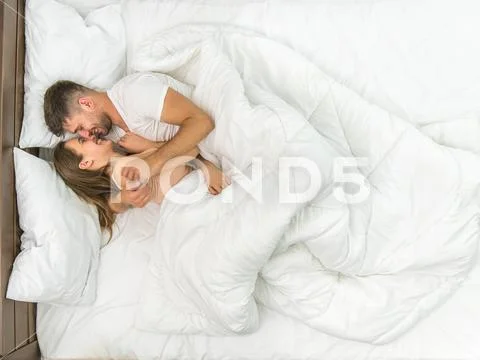 The couple kiss in the white linens. View from above Stock Photos