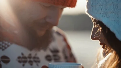 Couple kisses and drinks coffee with marshmallow in winter forest Video stock 99151053