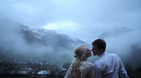 Couple kissing on the background of mountains Stock Footage 64775845