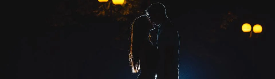 The couple kissing on the dark alley. night time Stock Photos