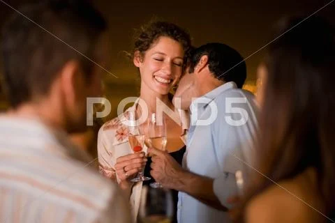 Couple Kissing At Party At Night