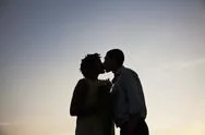 A Couple Kissing At Sunset Stock Photos