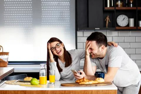 Couple in the kitchen at breakfast time Stock Photos
