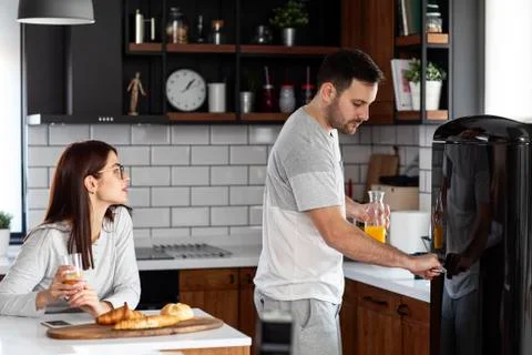 Couple in the kitchen at breakfast time Stock Photos