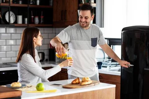 Couple in the kitchen at breakfast time Stock Photos