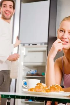 Couple in kitchen having breakfast Stock Photos