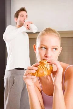 Couple in kitchen having breakfast Stock Photos