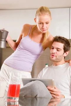 Couple in kitchen having breakfast Stock Photos