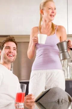 Couple in kitchen having breakfast Stock Photos