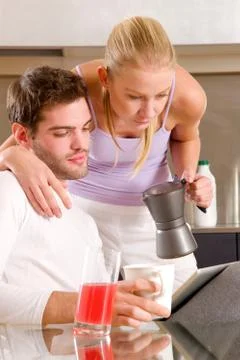 Couple in kitchen having breakfast Stock Photos