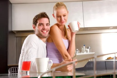 Couple in kitchen having breakfast Stock Photos