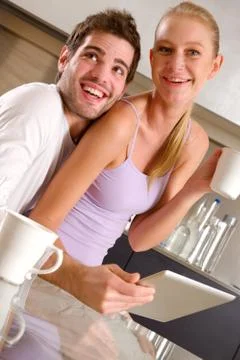 Couple in kitchen having breakfast Stock Photos