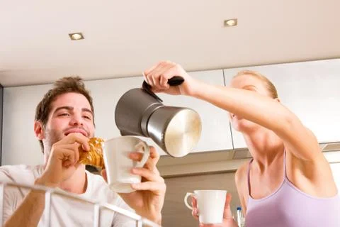 Couple in kitchen having breakfast Stock Photos
