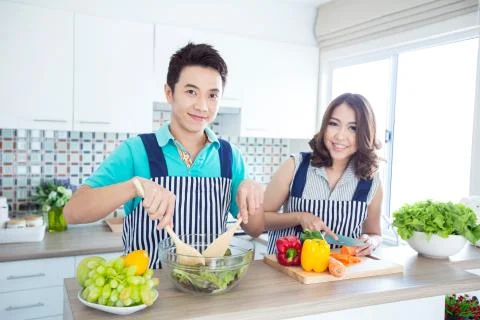 Couple in kitchen Stock Photos